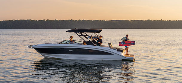 Sea Ray SDX 290 still in water with group of people with wakeboarding gear