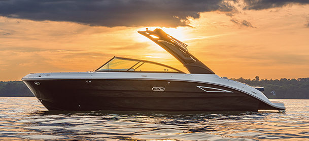 SDX 250 floats on calm water at sunset, silhouetted against an orange sky.