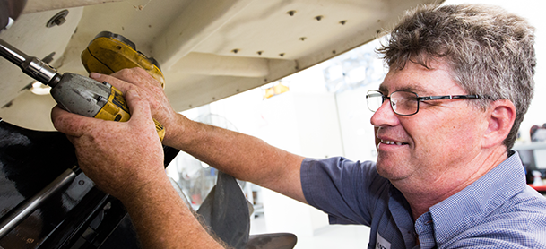 A marinemax technician works on fixing a boat
