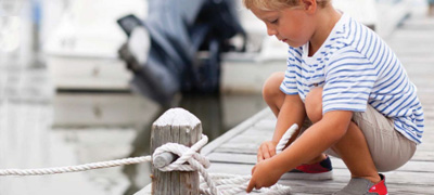 Kid tying the boat to the dock