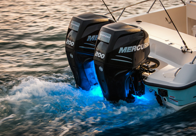 two mercury outboard engines illuminate rear of boat