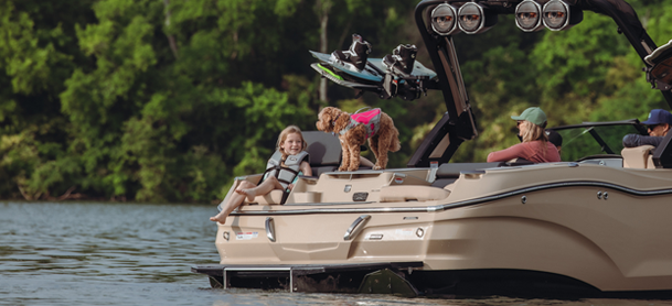 Couple getting ready to jump off the back of a boat