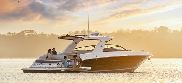 Sea Ray SLX 400 in the water with sunrise in the background