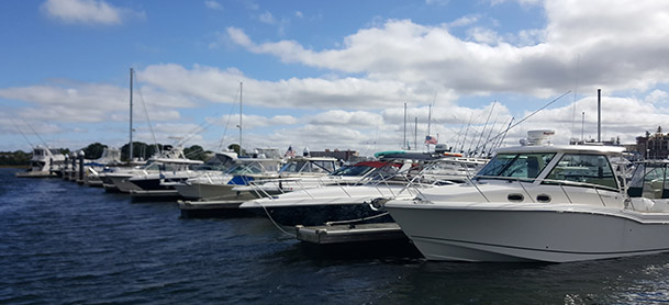 several boats lined up along a dock