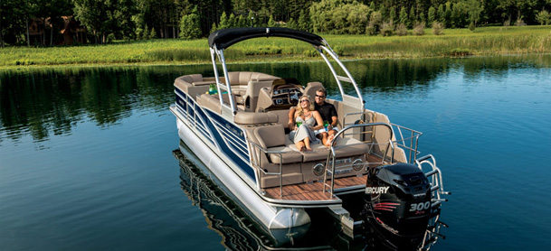 Couple relaxing on back of pontoon boat