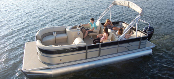 Group of people lounging in a pontoon boat out on the water