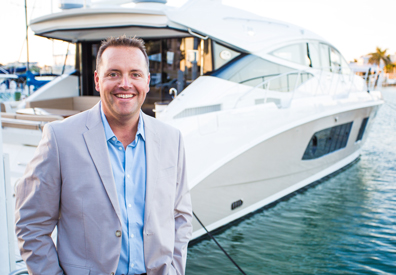 businessman standing in front of charter yacht