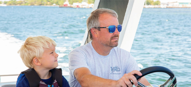 Father and son driving Galeon Yacht
