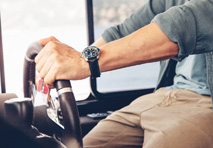 close up of a man holding a boat steering wheel