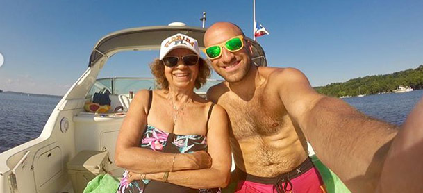 A man and woman smile for a selfie on a boat