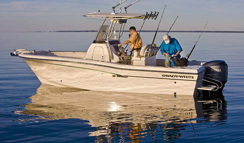 A Grady-White 230 boat with men getting ready to fish at sunrise