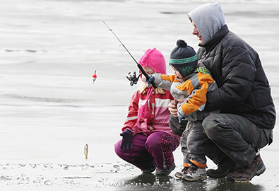 Father and kids ice fishing