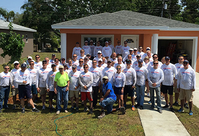 MarineMax team in front of Habit Humanity House