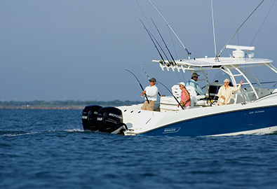 Boston Whaler Outrage in deep blue water with people fishing on it