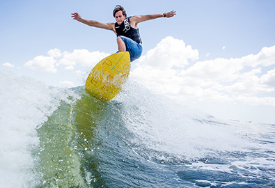 Boy wakesurfing behind a boat