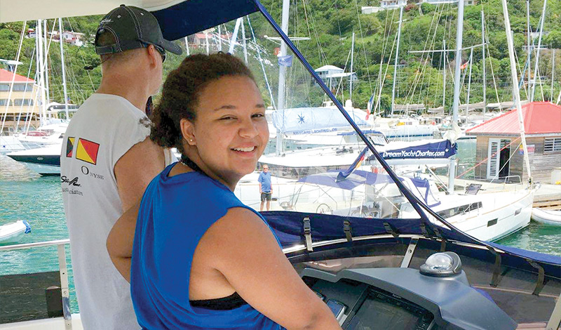 father and daughter at the helm of a marinemax vacations 484 in the british virgin islands