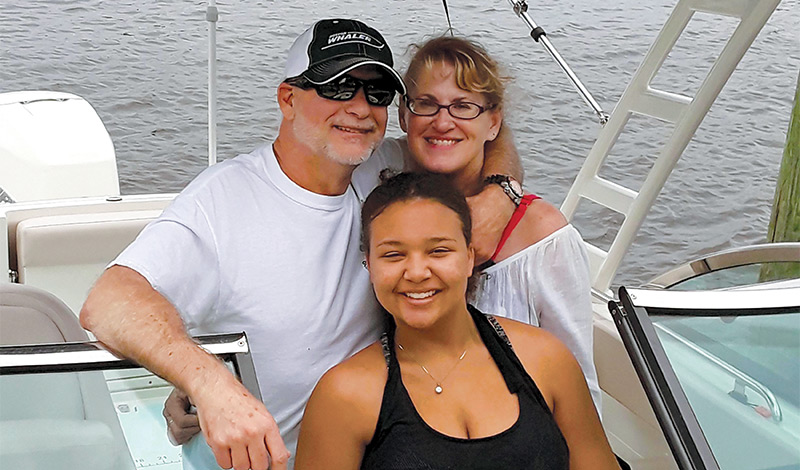 hale family on their boston whaler vangage boat smiling