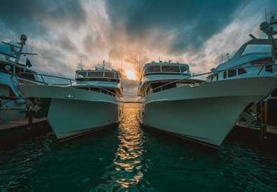 sun setting between boats