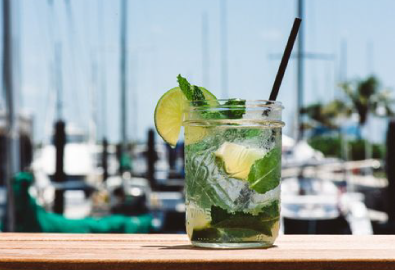 Mojito in a glass with boats and yachts in the background