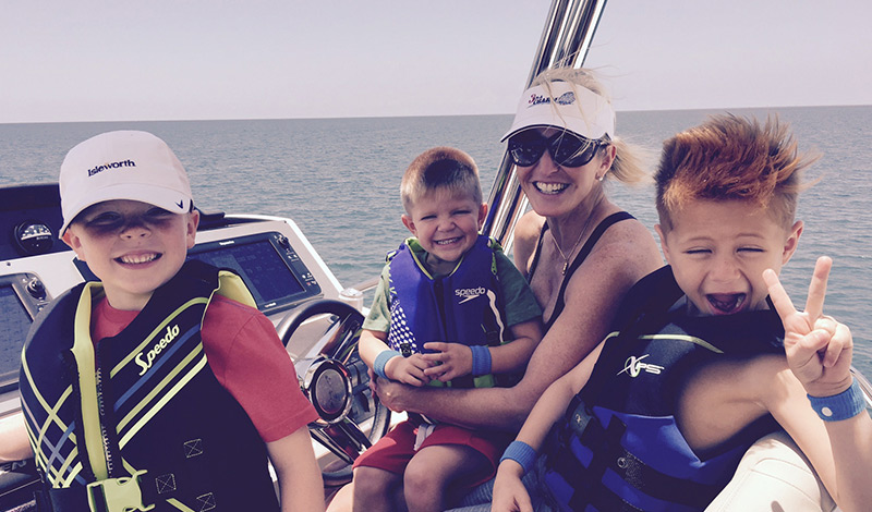 stacey with her family on her sea ray