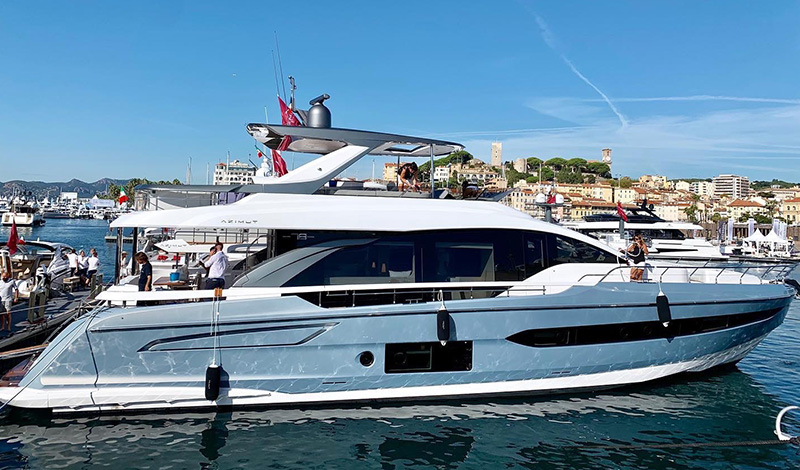 a profile view of an azimut yacht docked in cannes france on a sunny day