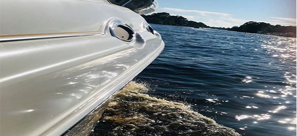Close-up view of a boat's hull as it moves along the water