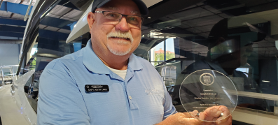 Keith Lake holding a boat safety award