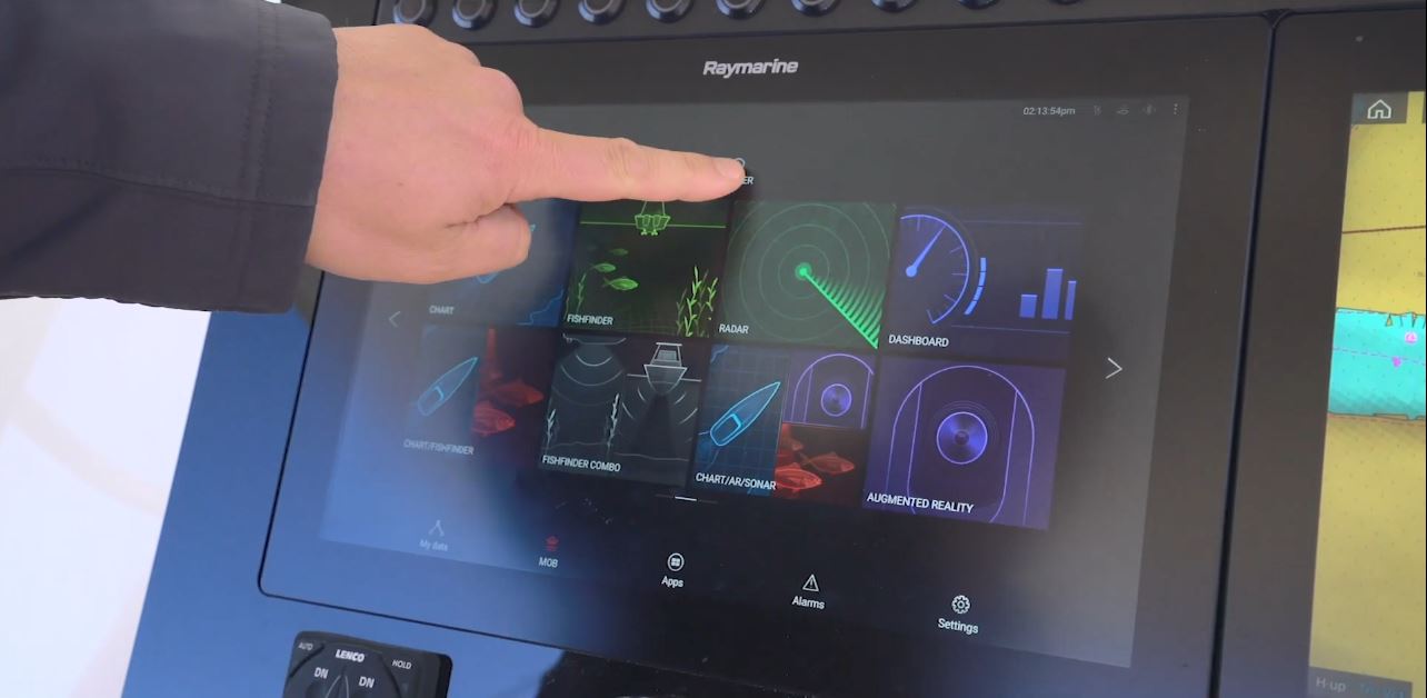 A hand using a touch screen boat navigation system