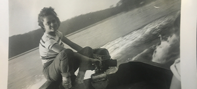 A woman boating on a Boston Whaler in black and white