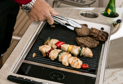 A grill on a boat with meat cooking on it
