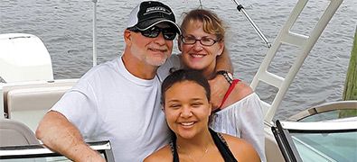 Hale family together on their boat smiling