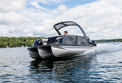 A Harris pontoon boat slowly cruising on the water