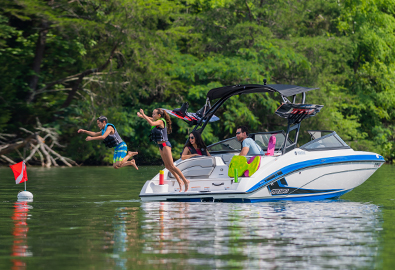 People jumping off a Yamaha boat into the water