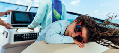 Kid taking a nap on a boat