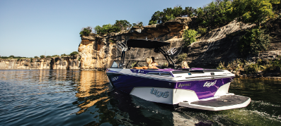 Tige boat out on the water with mountain views