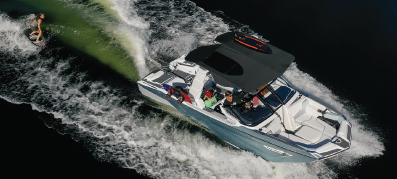 A boat running out on the water with a wakeboarder