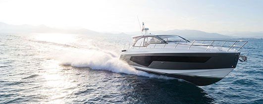 an azimut atlantis 51 cruising through blue water as the sun shines behind it