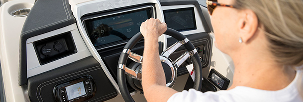 woman driving a harris pontoon