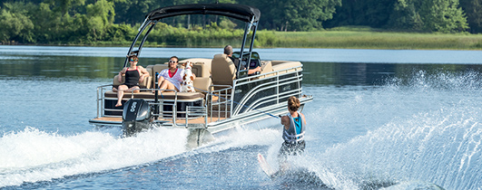 people waterskiing and having fun on a harris pontoon