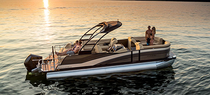 two coupes enjoying the sunset on a harris pontoon