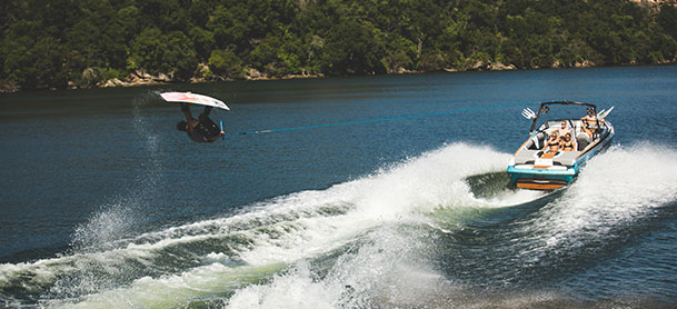 a wakeboarder in the air while being towed by a tige boat