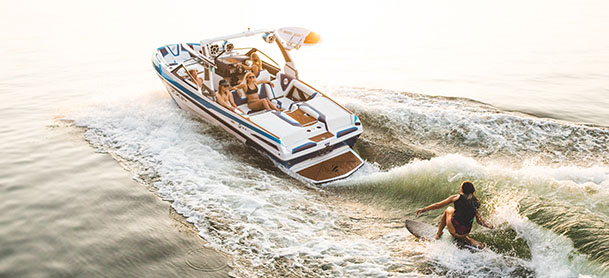 a wakeboarder in the water while being towed by a tige boat