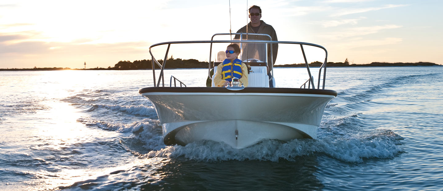 A front view of a Boston Whaler 170 Montauk cruising in calm waters
