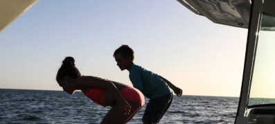 Kids jumping off the boat