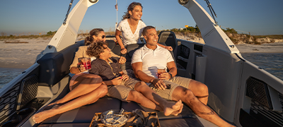A family lounging on their Harris Crowne 250 SL pontoon