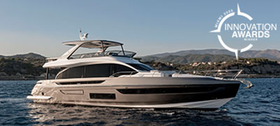 A sleek, modern yacht sails on calm waters with 2025 Innovation Awards Winner logo in the top right.