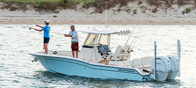 Two fishermen casting a line from a Grady White model