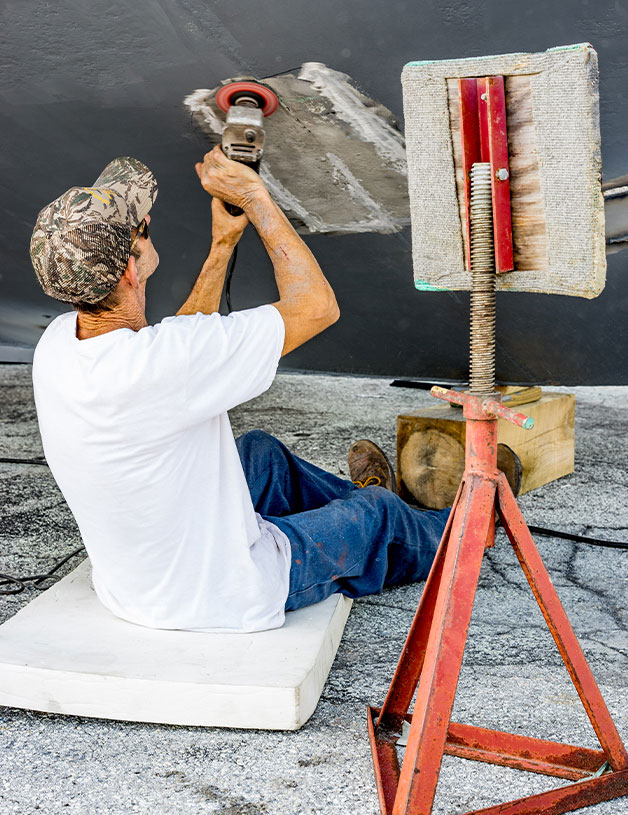 Man sanding boat