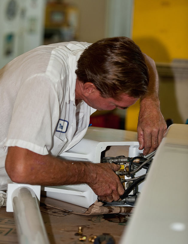 service team member working on part of boat