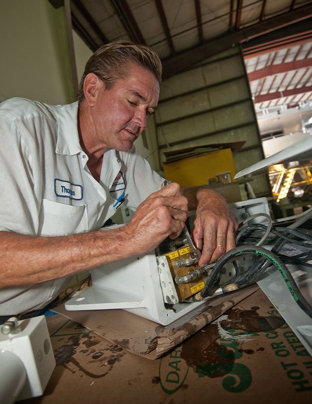 Service technician repairing part of boat